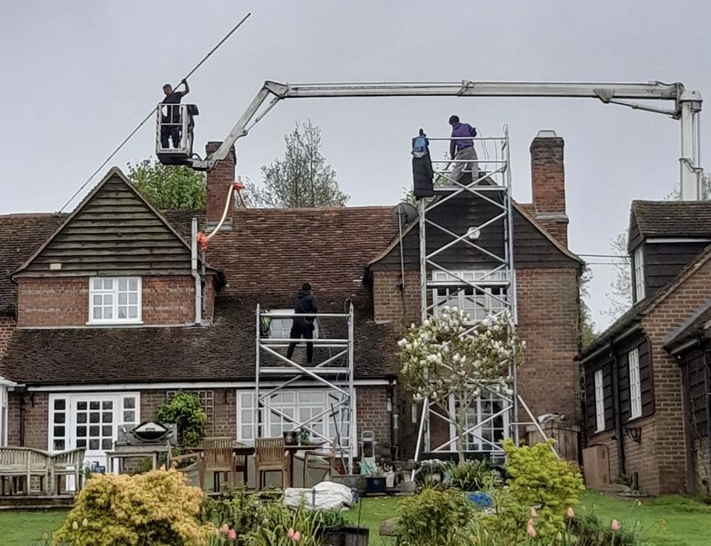 The Roof Moss Cleaners using cherry picker and scaffolding to clean roof safely and professionally in Brixworth, Northamptonshire