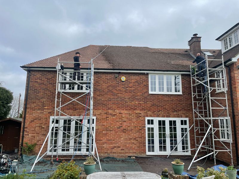 Roof cleaning carried out safely from scaffold towers by The Roof Moss Cleaners in Brixworth